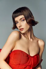stock-photo-stylish-young-woman-showcases-beauty-vibrant-red-dress-big-bow.webp