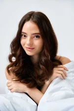 stock-photo-radiant-young-woman-flowing-hair-relaxes-comfortably-exuding-sense-calm.webp